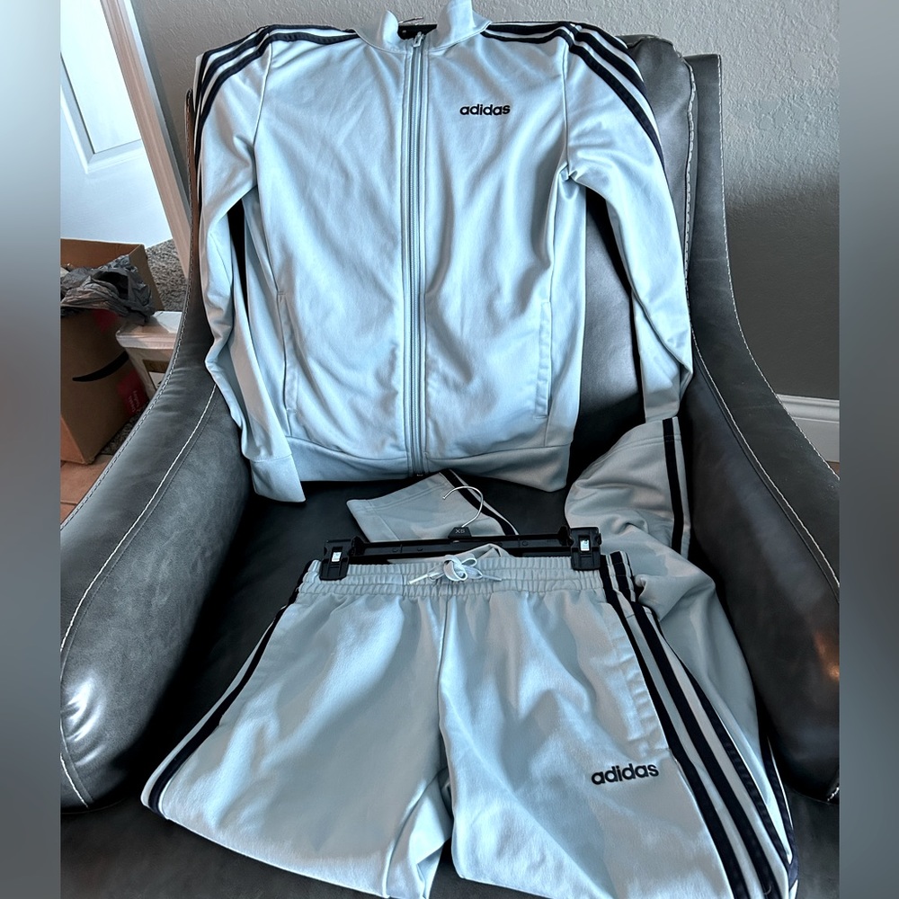 Adidas track suit. Sky blue with navy stripes. Jacket x-small pants x-small.